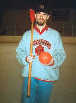 Jim Ellwanger holding a broomball stick